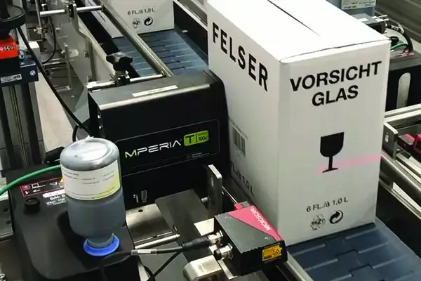 T-Series piezo inkjet printing system marking on white wine boxes in black ink.