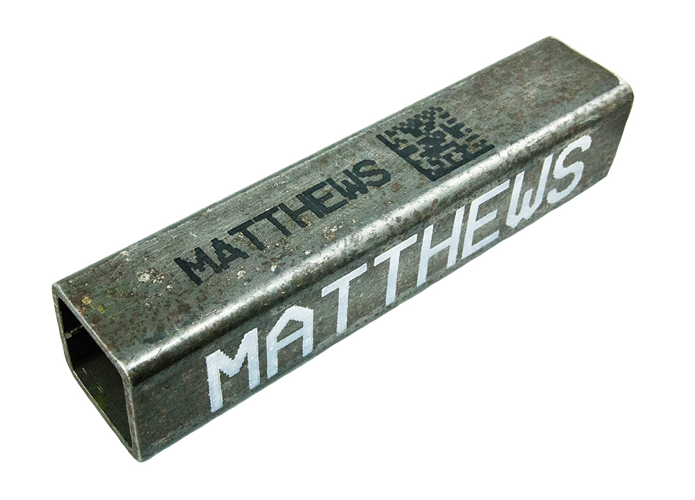 Metal marking in black and white ink on square pipe.