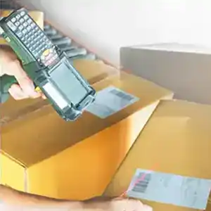 Using a scanner on barcode on brown box.