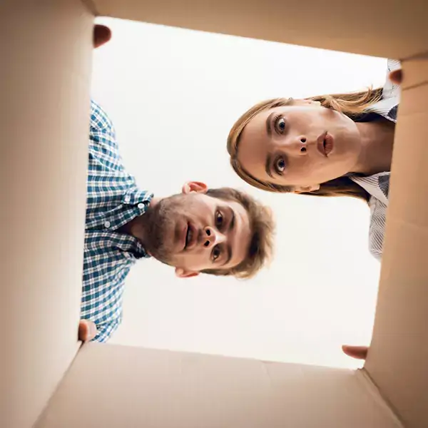 Man and Women staring down into a cardboard box. 