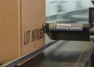 The V-Series DOD inkjet printer marking a cardboard box on a conveyor.