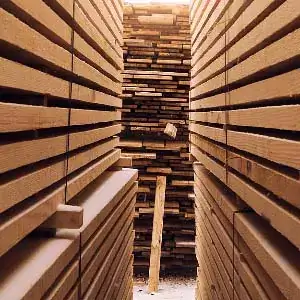 Featured image 300x200. Stacked lumber in an lumber yard that looks like you're in a lumber maze.