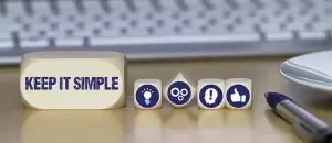 Image of five blocks on a desk. The largest block has the text "keep it simple" on it.