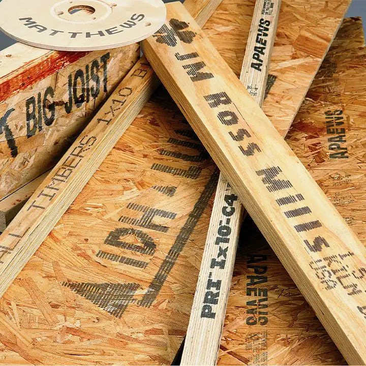 Engineered lumber and wood panels marked with durable industrial codes for identification and traceability.