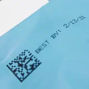 2D barcode and best-by date printed on blue plastic flexible packaging using the MPERIA Axian XIJ printer.