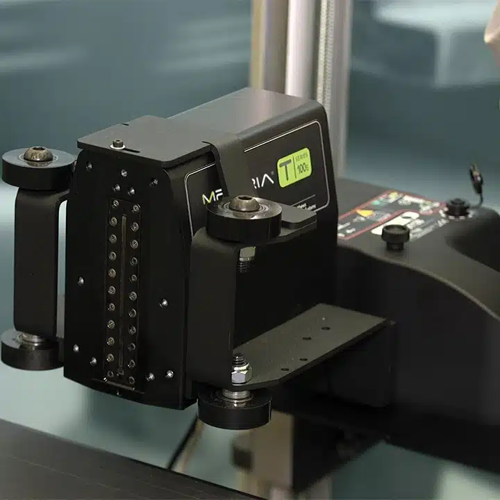 T-Series thermal inkjet printer mounted on a custom adjustable bracket for precise product coding and marking in industrial manufacturing environments.