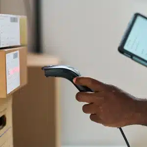 Man with a scanner and tablet verifying 2d barcodes