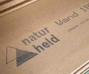 A V-series mark on wood with the Naturheld logo and brand name