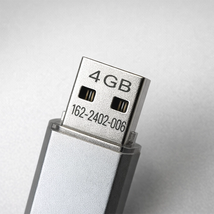 Laser-marked USB flash drive with permanent serial number for product identification and traceability.