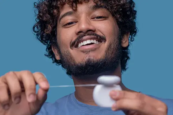 Man using dental floss for oral care