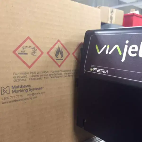 Hazard symbols and safety text printed on a corrugated carton