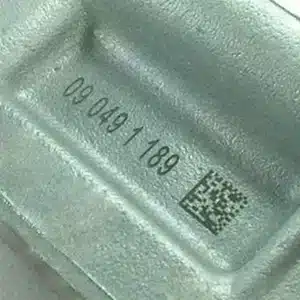 2D code and alphanumeric text marked on metal