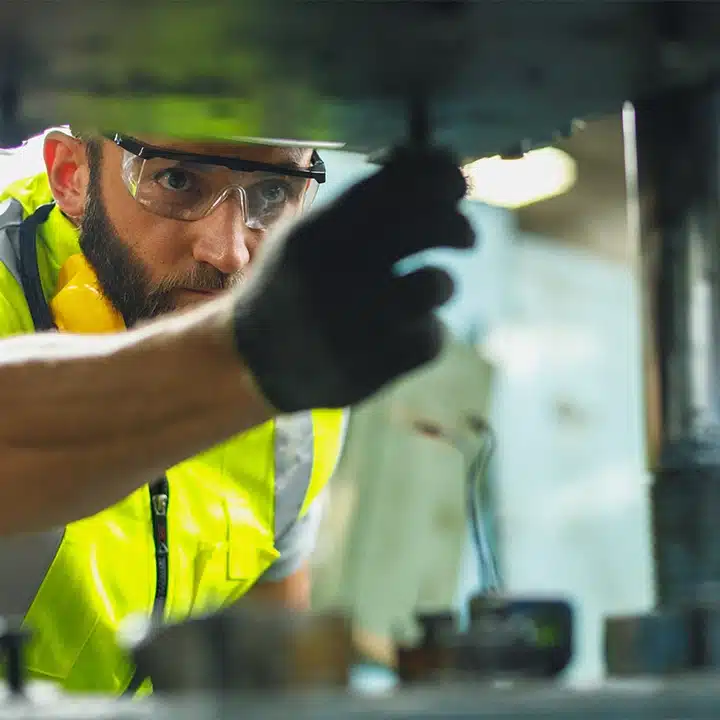 Technician performing maintenance on industrial marking and coding equipment.
