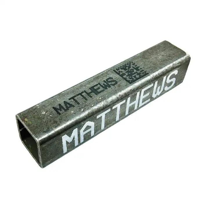 Metal marking in black and white ink on square pipe.