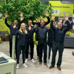 happy team with hands up at a successful trade show
