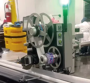 An A-Series print and apply labeling system operates on a produce packaging line, applying labels to packaged products in an automated production environment.