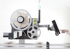 Product view of the A-Series D43 print and apply labeler, showing the label roll, applicator arm, and controls used for automated labeling applications.