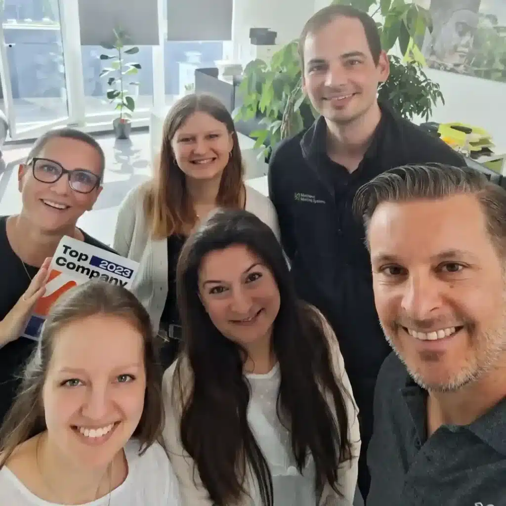 selfie smiling employees with top company award