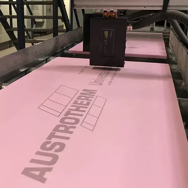 Industrial printer marking text on insulation board
