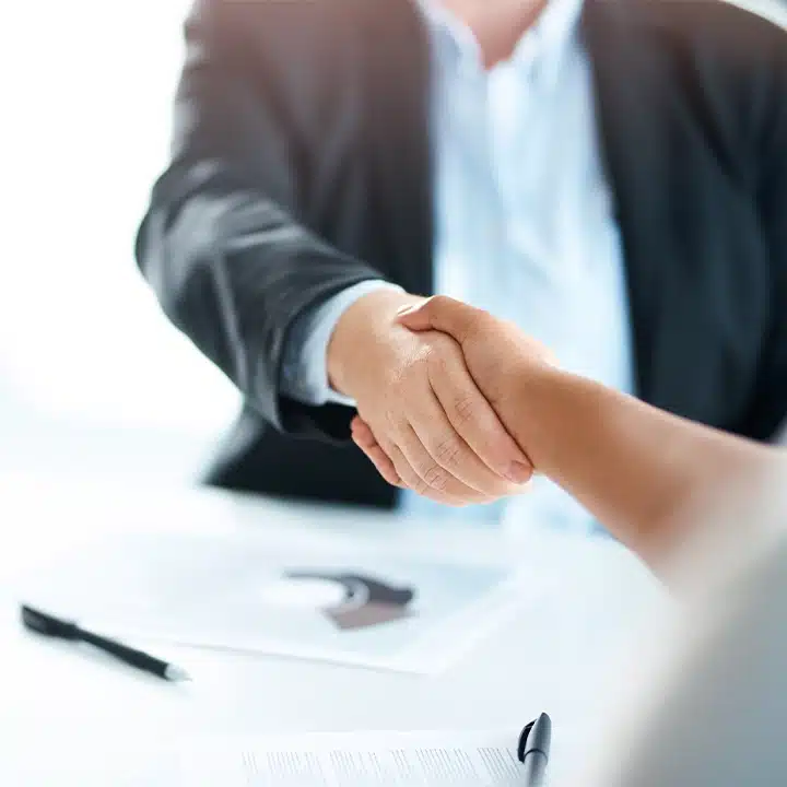 handshake collegues after signing new contract