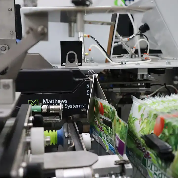 Matthews L-Series thermal inkjet printer marking produce bags on a high-speed packaging line.