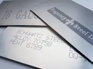 Industrial inkjet-printed alphanumeric codes and identification markings on overlapping metal sheets.