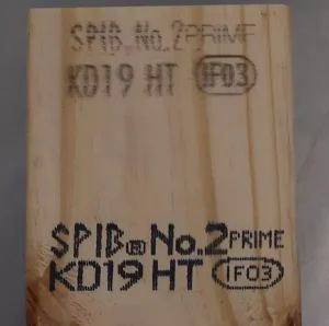 Comparison of CIJ and DOD valvejet printing on wood, showing a faint CIJ mark above a larger, darker valvejet code.